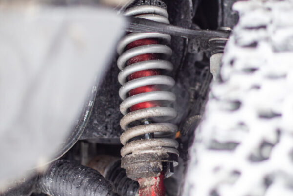 cutaway view into wheel well of installed JRZ AT suspension shock on Ford Raptor, installation by Olsen Motorsports